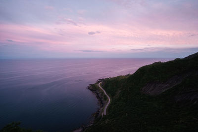 Scenic view of coastal road against sky during suset