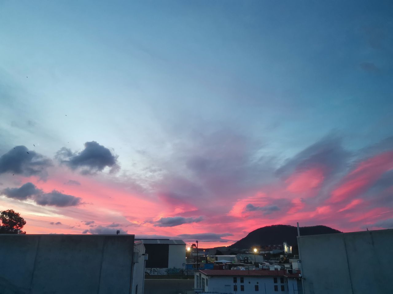 BUILDINGS AGAINST SKY AT SUNSET