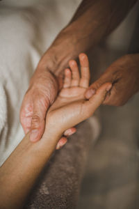 A man massages a woman's hand close up