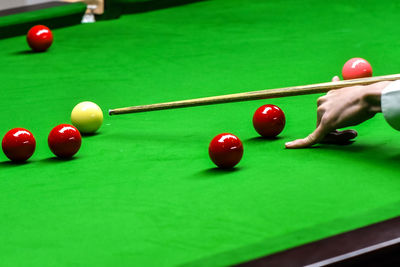 Cropped hand playing pool