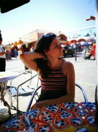 Young woman sitting at outdoors cafe on beach