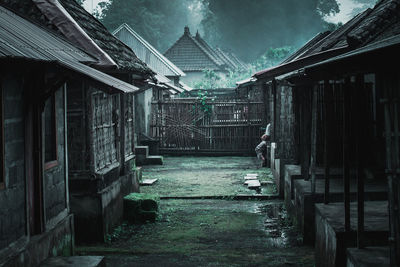 Old abandoned house amidst buildings