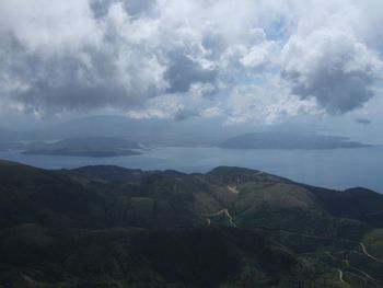 Scenic view of mountains against cloudy sky