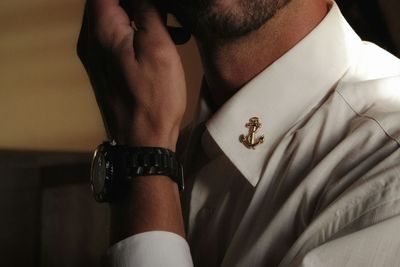 Close-up of man wearing shirt and wristwatch