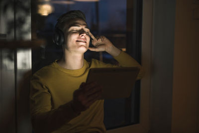 Young man using mobile phone at home