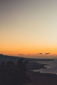 Scenic view of sea against clear sky during sunset