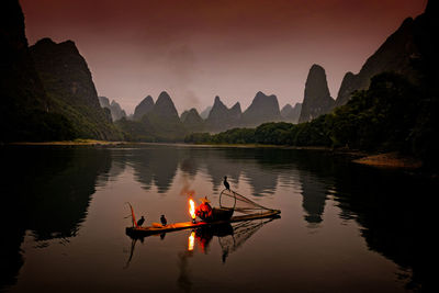 Scenic view of river against sky during sunset