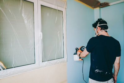 Rear view of man working at home