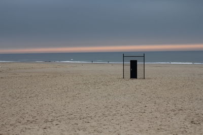 Scenic view of beach against sky during sunset