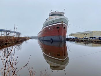 Panoramic view of boats moored in lake against sky