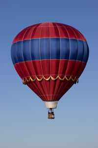 Low angle view of hot air balloon against clear blue sky