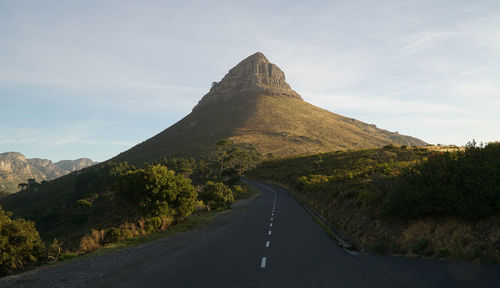 Surface level of empty road against mountain range