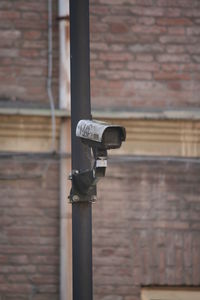 Close-up of metal against brick wall