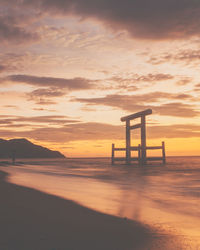 Scenic view of sea against orange sky