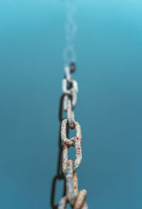 Close-up of chain against blue background