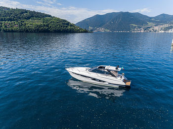 High angle view of boat moored on lake against mountain