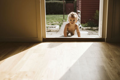 Toddler crawling through door