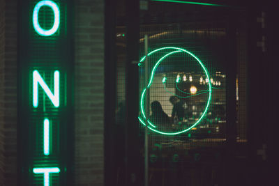 Illuminated information sign of store at night