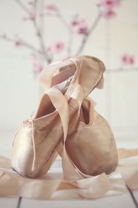 Close-up of shoes on bed