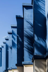 Low angle view of modern building against clear blue sky