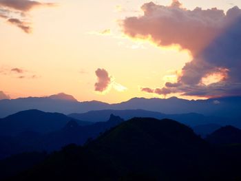 Scenic view of silhouette mountains against sky during sunset