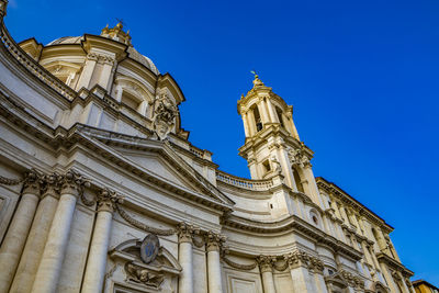 Low angle view of statue of temple against clear blue sky