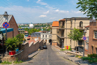 Street amidst buildings in city against sky