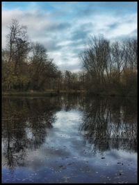 Scenic view of lake against cloudy sky