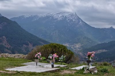 Scenic view of mountains against cloudy sky