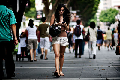 Woman walking on street in city