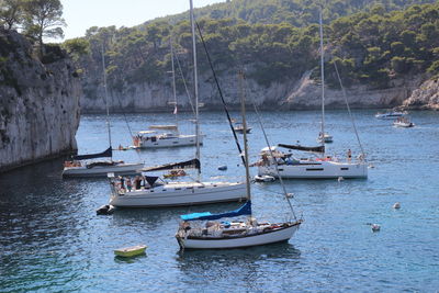 Sailboats moored at calanque harbor against clear blue sky on the french riviera