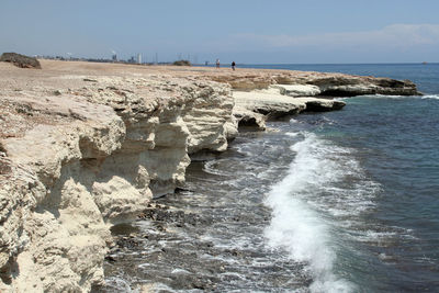 Scenic view of rocks on beach against sky