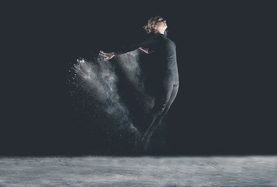 Studio shot of young woman dancing