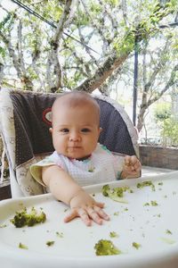 Portrait of baby sitting on high chair
