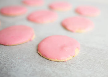 Sugar cookies with pink frosting on gray kitchen island