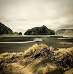 Scenic view of mountains against cloudy sky