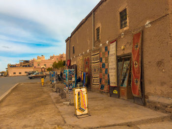 Street amidst buildings against sky in city