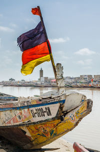 Boat moored on sea against sky