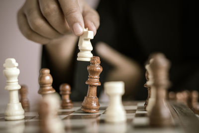 Low angle view of man relaxing on chess board