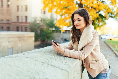 Young woman using mobile phone outdoors