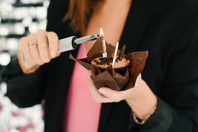 Midsection of man holding cigarette