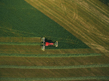 Aerial view of machinery working in agricultural field