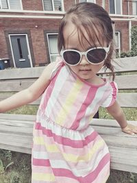 Portrait of girl wearing sunglasses standing outdoors