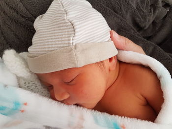 Close-up of baby sleeping on bed