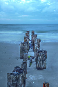 Dawn over a dilapidated pier on the beach in port royal in naples, florida.