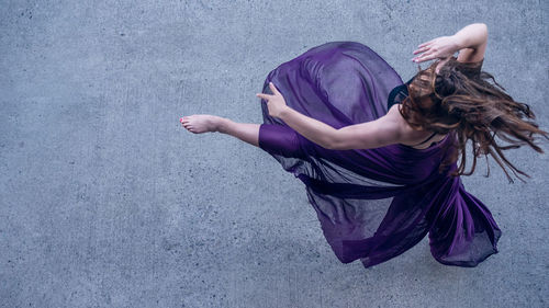 High angle view of woman dancing against wall