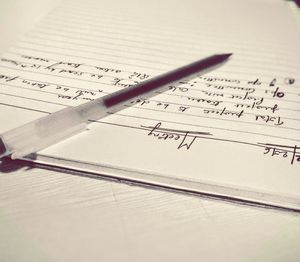 Close-up of pen on book