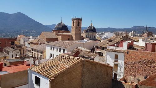 Buildings in town against clear sky