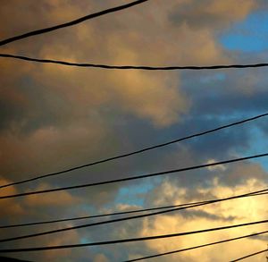 Low angle view of power lines against sky