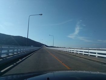 Road against sky seen through car windshield